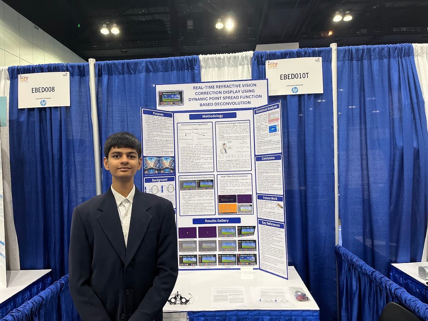 Dhruv Ramu standing beside the project poster for the real-time vision-correcting display at the International Science and Engineering Fair 2024